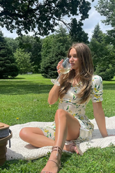 a lady wears a floral printed silk maxi dress